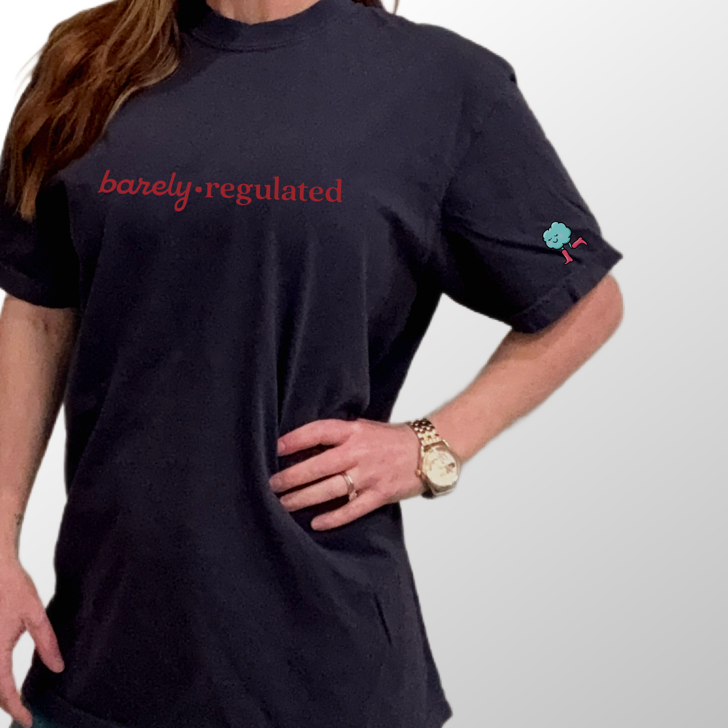 Person wearing a navy t shirt with barely regulated on chest.
