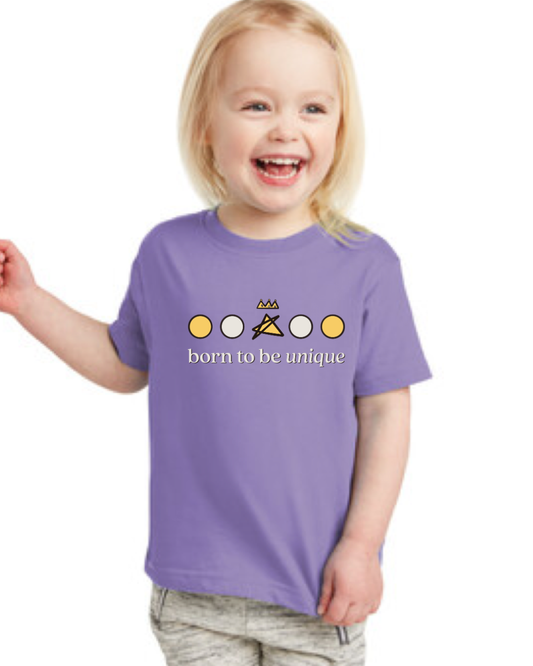 Child wearing a purple t-shirt with a colorful design and 'born to be unique' text 